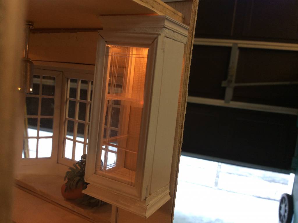 Glass front lighted kitchen cabinets, with glass shelves.